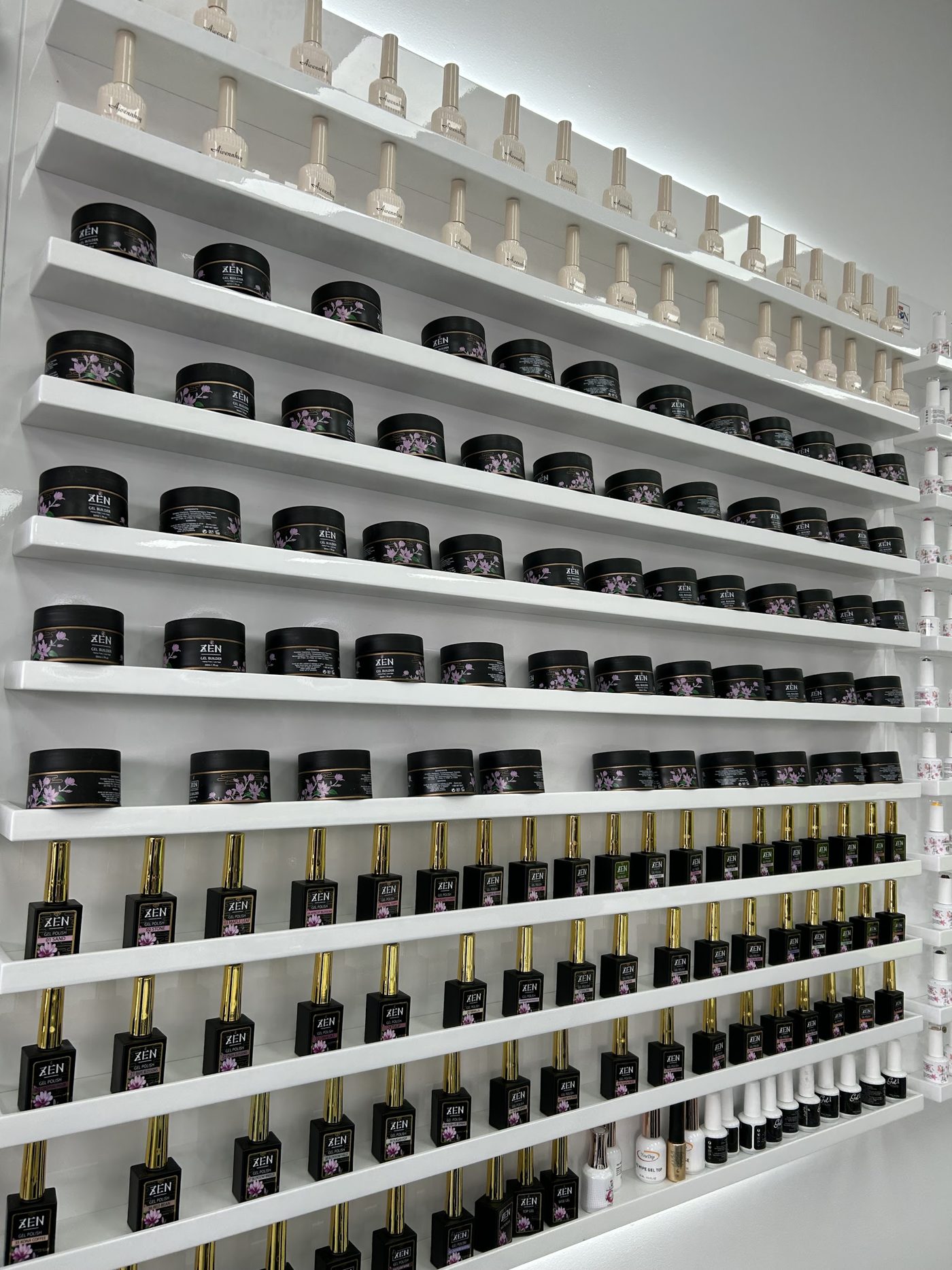 Shelves of ZEN builder gel pots and gel polish bottles
