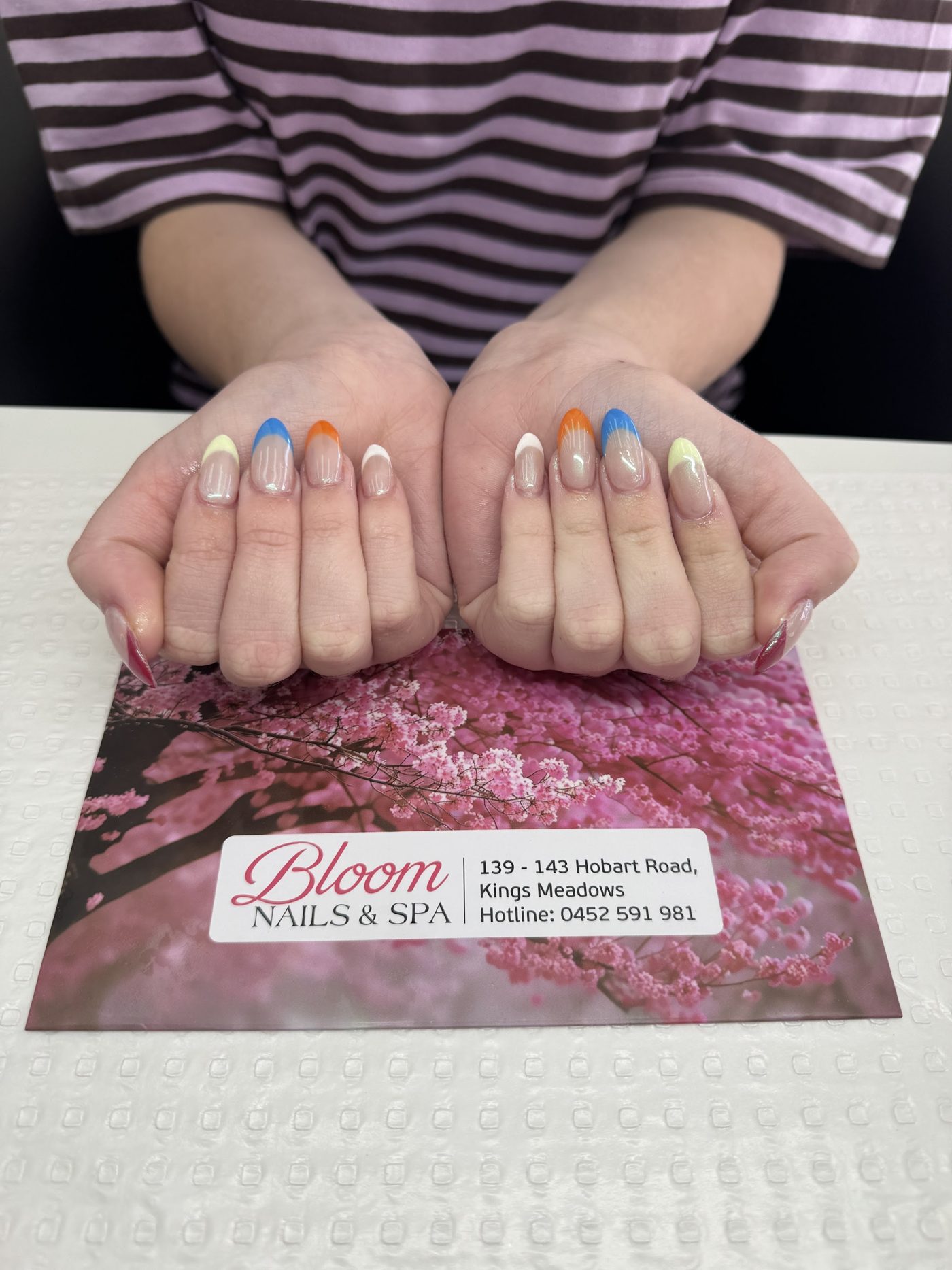 Colour-block French tips in orange, blue and yellow